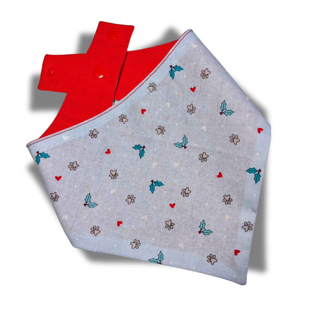 Handmade eco-friendly dog bandana with Christmas paw print design and festive red reverse, snap-on style with poppers - The Jazzy Pooch