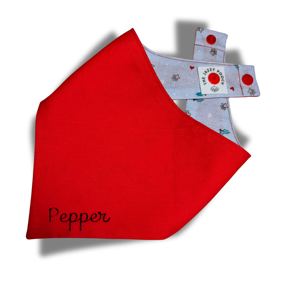 Reversible Christmas dog bandana showing festive red side with custom name, handmade from sustainable reclaimed fabrics with adjustable snap fasteners - The Jazzy Pooch