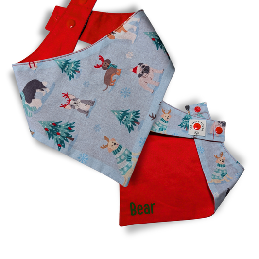Christmas dog bandana featuring playful pups in winter scene  with a festive red personalised reverse - The Jazzy Pooch

