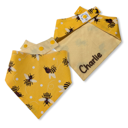 Sustainable reversible dog bandana showing dancing bee pattern and primrose yellow reverse with personalised pet name - The Jazzy Pooch