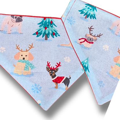 Sustainable slip-on dog bandana in soft pale blue displaying playful festive pups with antlers,  red reverse, handmade over-the-collar Christmas accessory - The Jazzy Pooch