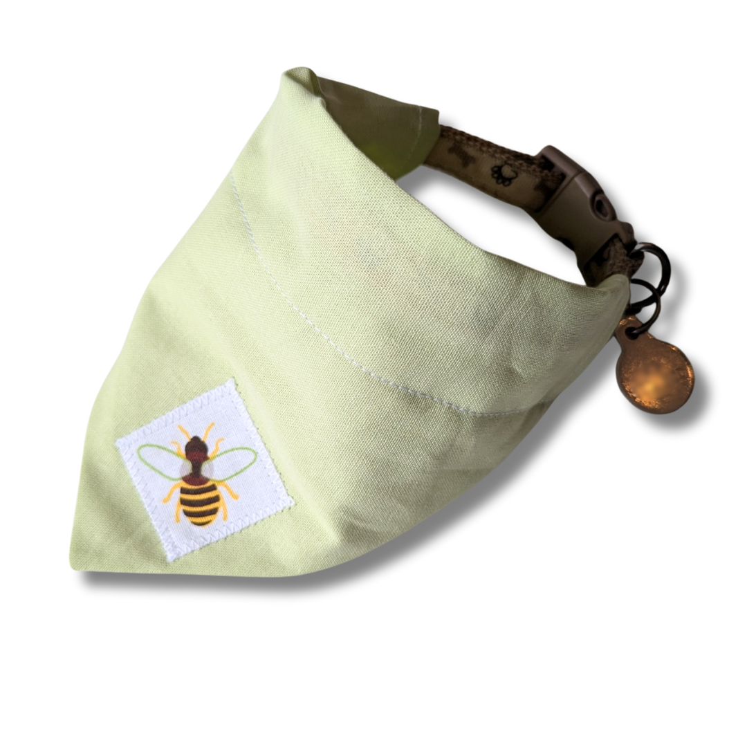 Eco-friendly slip-on dog bandana in soft green featuring charming appliqué bee motif, planet-friendly over-the-collar style - The Jazzy Pooch