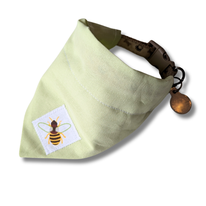Eco-friendly slip-on dog bandana in soft green featuring charming appliqué bee motif, planet-friendly over-the-collar style - The Jazzy Pooch