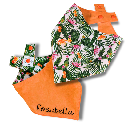 Reversible dog bandana displaying vibrant jungle flower pattern and tangy orange reverse, handcrafted from rescued sustainable fabric - The Jazzy Pooch