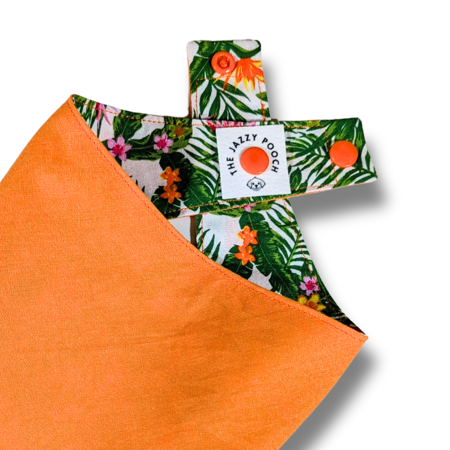 Quality detail showing The Jazzy Pooch branded label and adjustable snap-on poppers on eco-friendly reversible dog bandana - The Jazzy Pooch