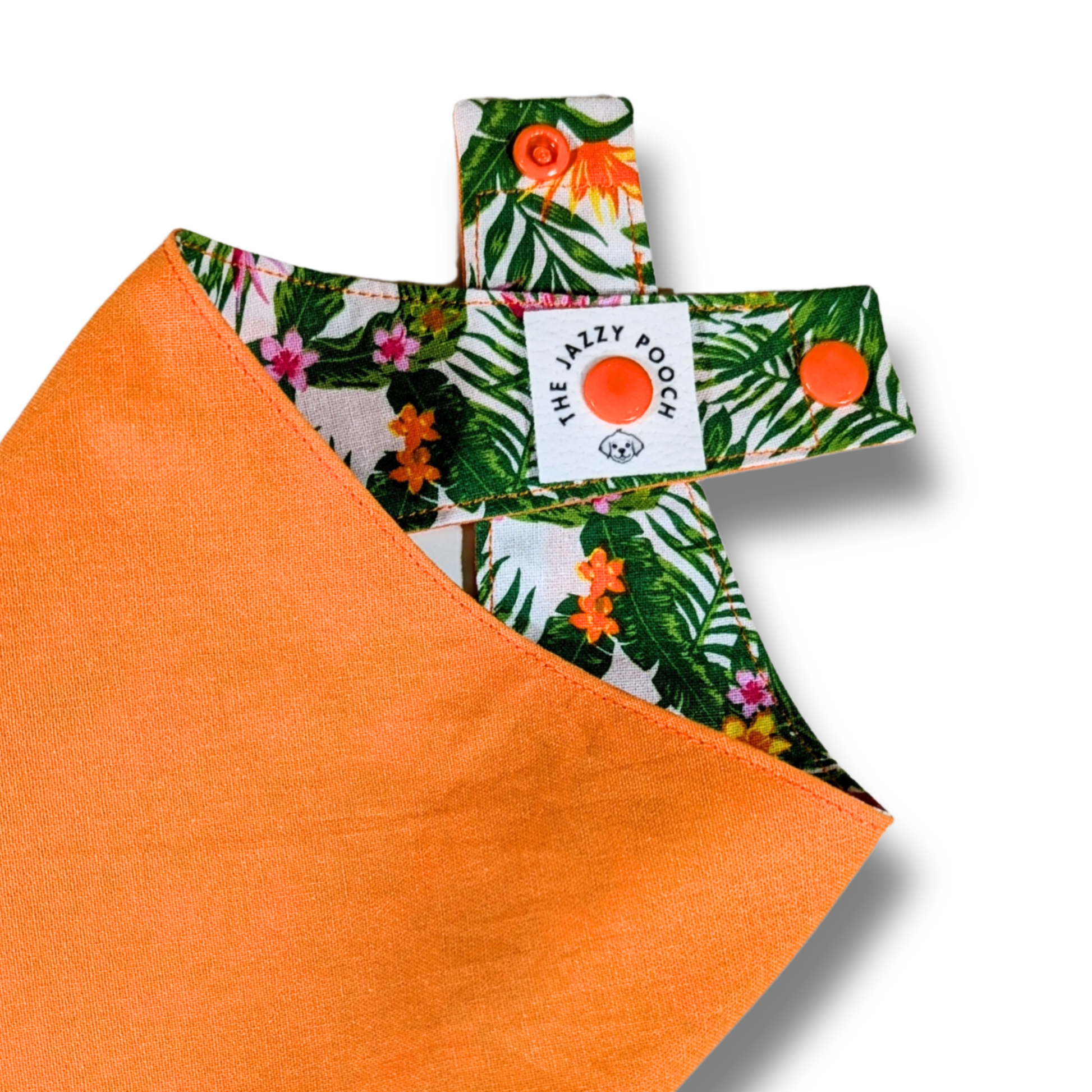 Quality detail showing The Jazzy Pooch branded label and adjustable snap-on poppers on eco-friendly reversible dog bandana - The Jazzy Pooch