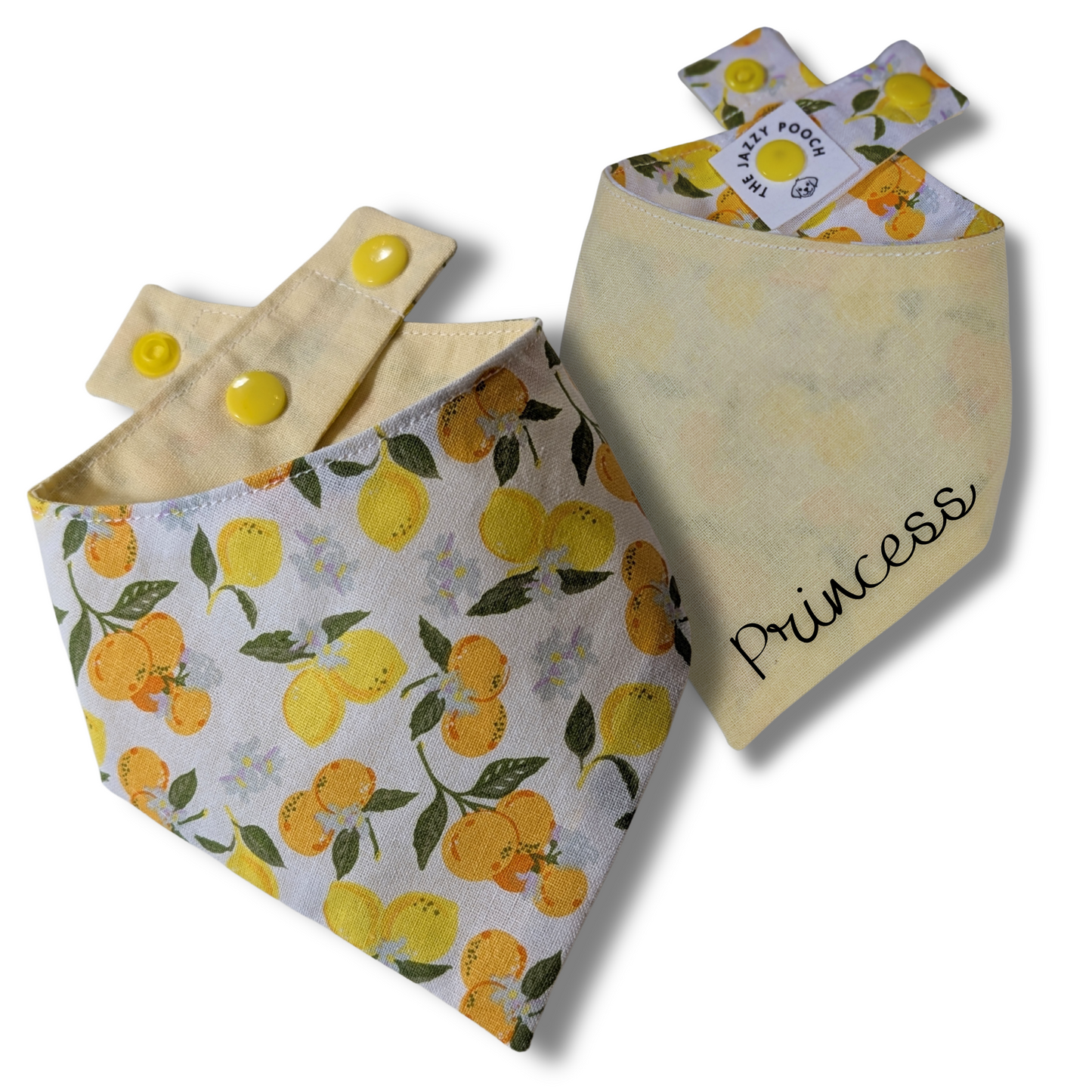 Reversible dog bandana displaying vibrant oranges and lemons pattern and sunny yellow reverse, handcrafted from sustainable reclaimed fabric - The Jazzy Pooch