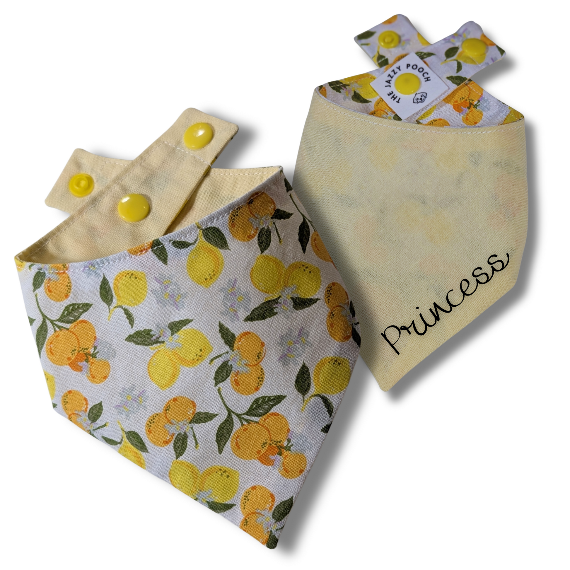Reversible dog bandana displaying vibrant oranges and lemons pattern and sunny yellow reverse, handcrafted from sustainable reclaimed fabric - The Jazzy Pooch