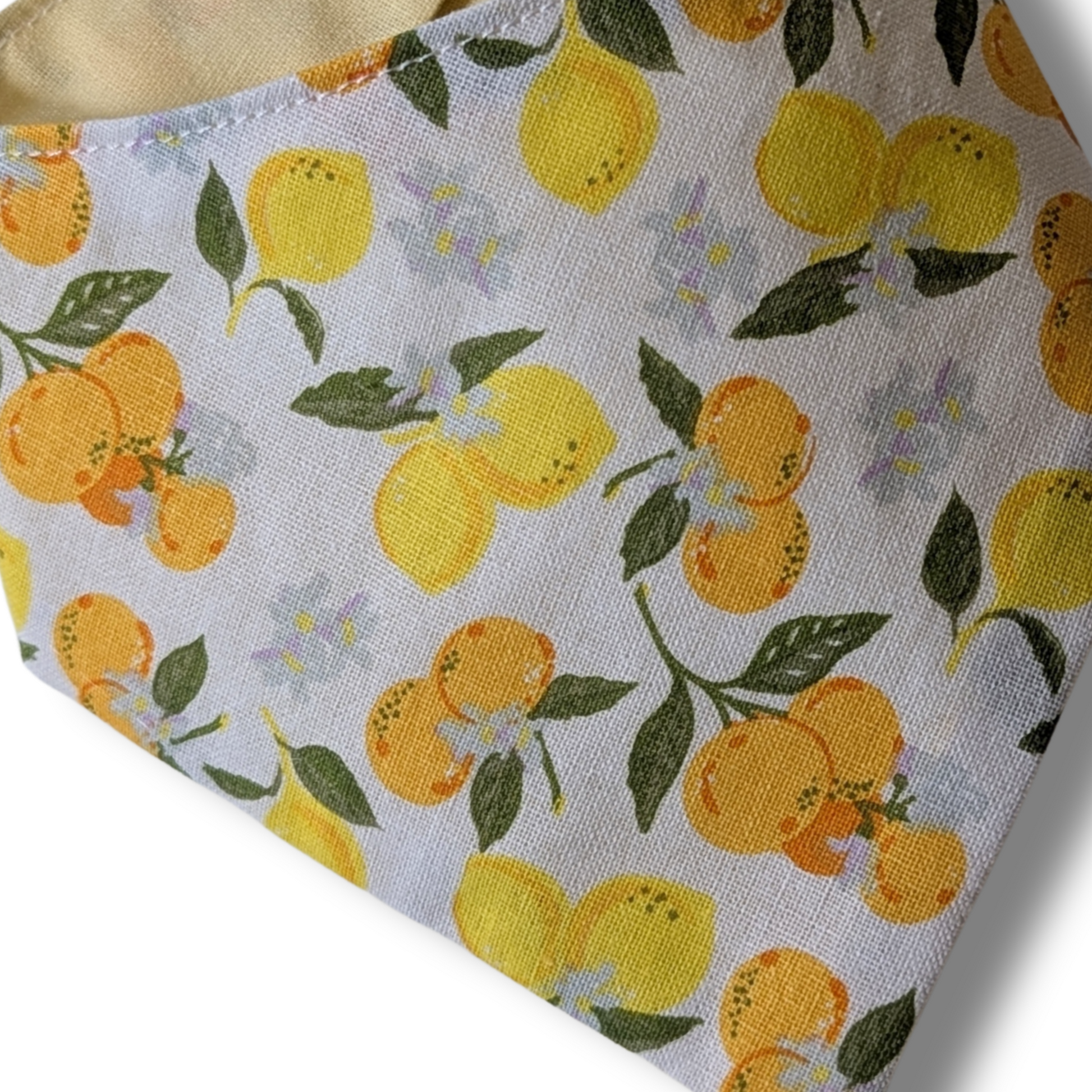 Close-up of fresh citrus oranges and lemons pattern on eco-conscious cotton dog bandana - The Jazzy Pooch