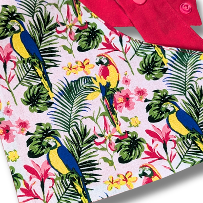 Close-up detail of colourful tropical parrot and jungle foliage design on planet-friendly dog bandana - The Jazzy Pooch