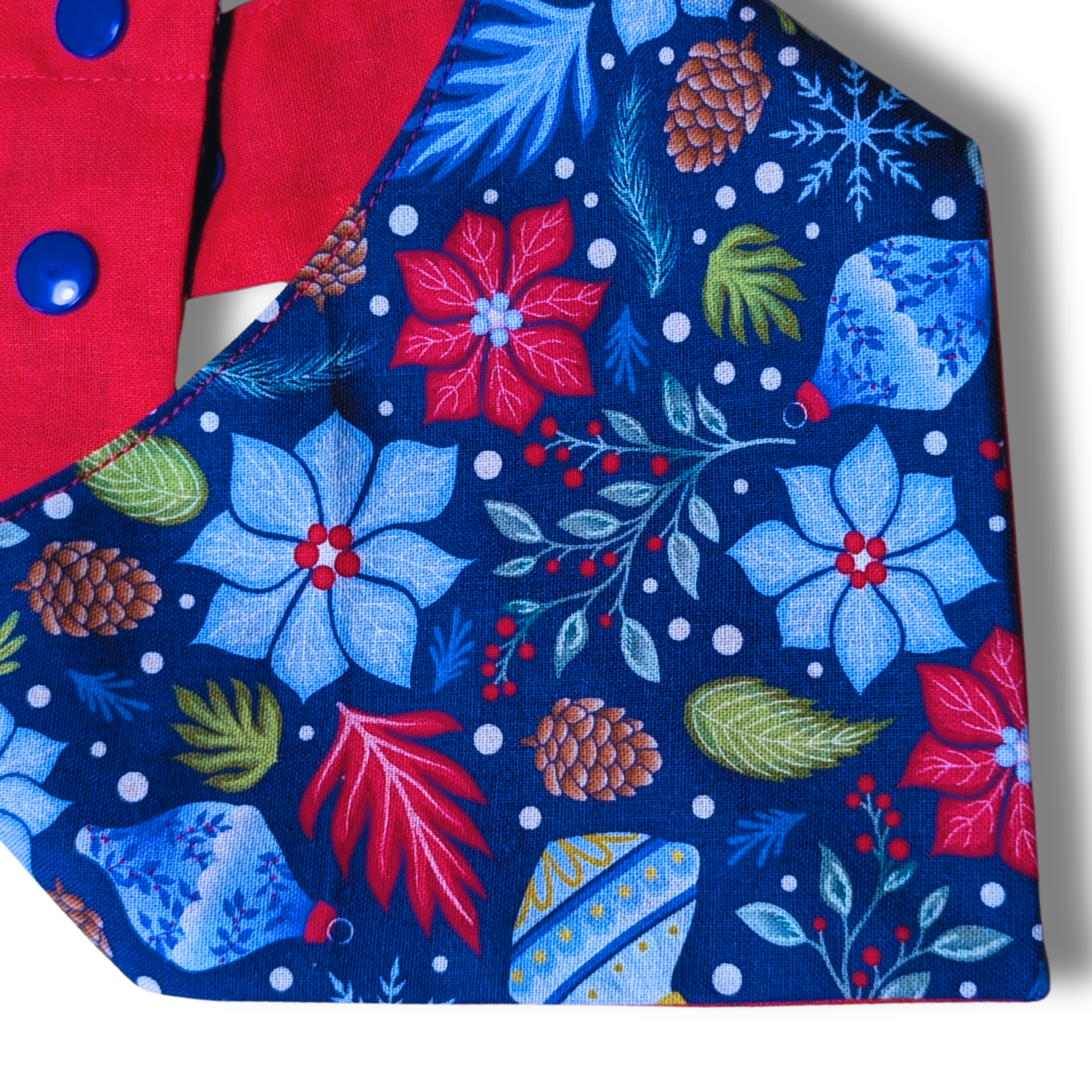 Close-up of festive poinsettia and Christmas bauble pattern on planet-friendly cotton dog bandana - The Jazzy Pooch