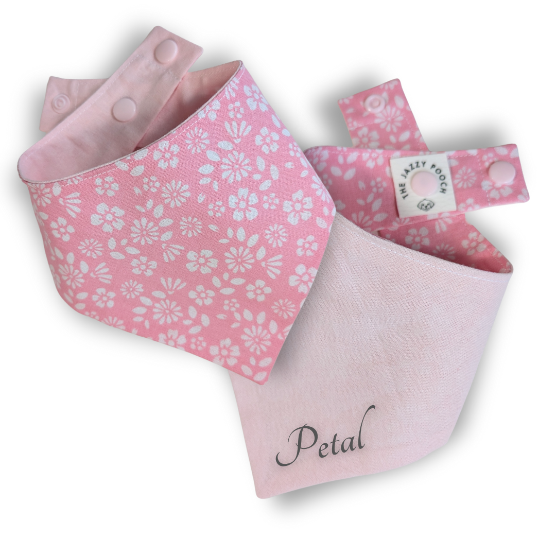 Sustainable pink reversible dog bandana showing vibrant spring florals on front and soft pastel pink reverse, customisable with pet name - The Jazzy Pooch