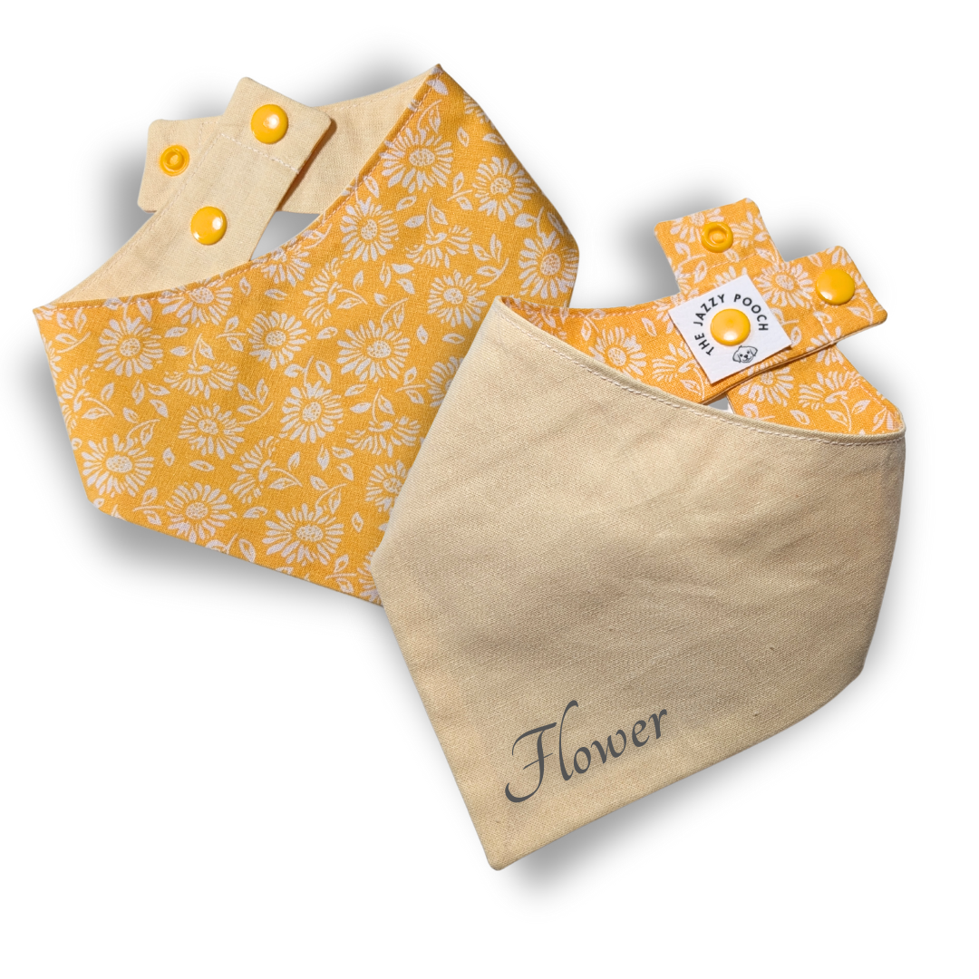 Handcrafted yellow reversible dog bandana displaying spring floral design and sunny yellow backing, personalisable with custom pet name - The Jazzy Pooch